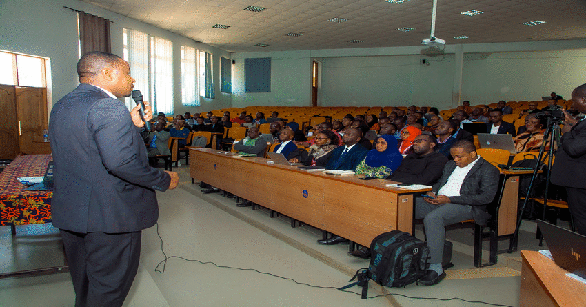 PPRA Director of Information System, Michael Moshiro, presents while Permanent Secretary for the Ministry of Information Mohammed Abdulla (second left) and members of Management of the ministry and participants of NeST training listen, recently in Iringa.